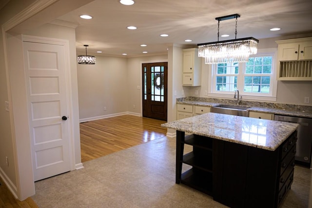 kitchen with recessed lighting, dishwasher, an inviting chandelier, and a sink