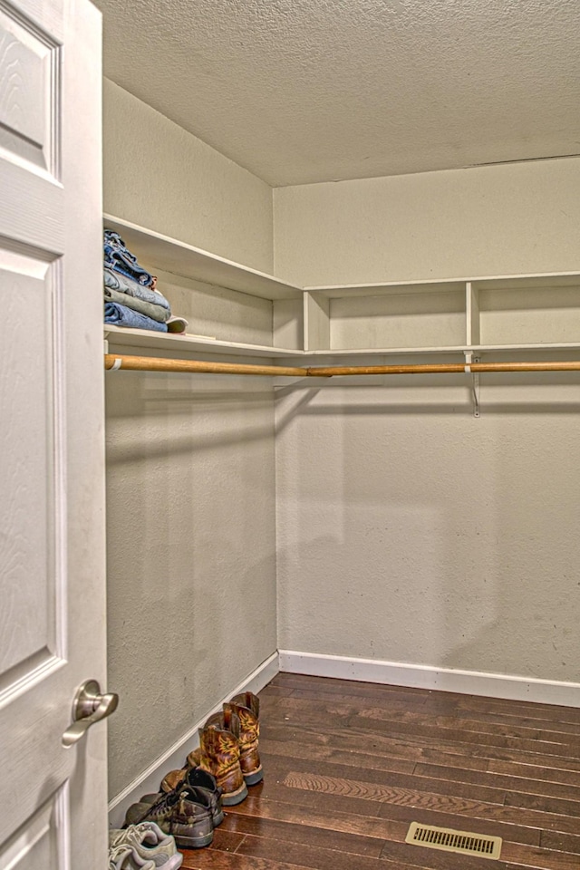 walk in closet with visible vents and hardwood / wood-style floors