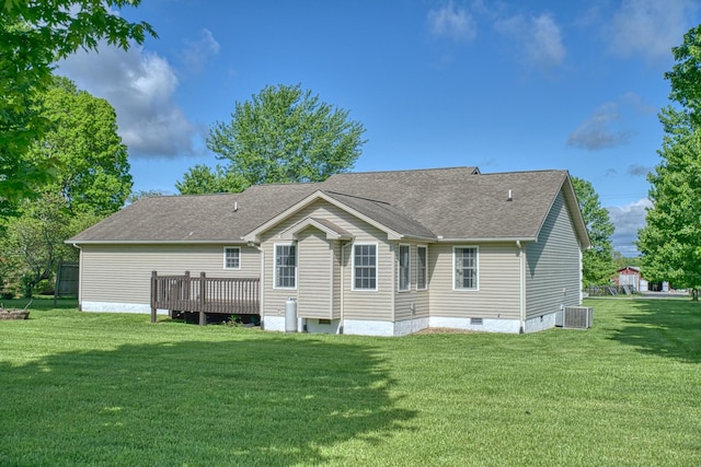 rear view of property with a yard, cooling unit, a shingled roof, and crawl space