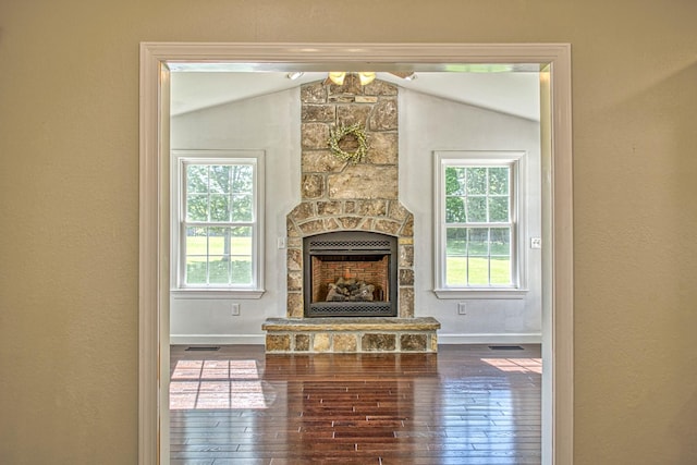 living area with lofted ceiling, a wealth of natural light, baseboards, and hardwood / wood-style floors