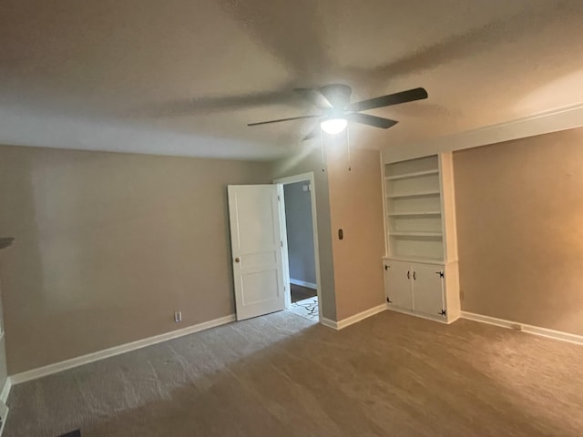 unfurnished bedroom featuring carpet flooring, baseboards, and a ceiling fan