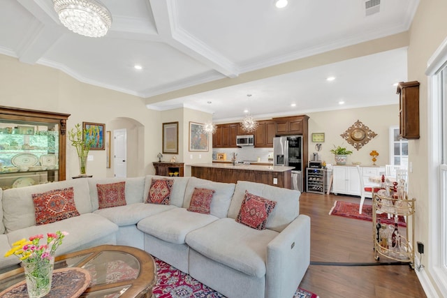 living room with visible vents, recessed lighting, dark wood finished floors, an inviting chandelier, and arched walkways