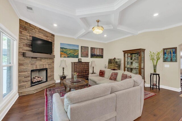 living room featuring ornamental molding, visible vents, a fireplace, dark wood-style floors, and baseboards