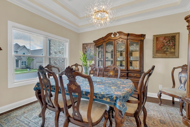 dining area with a chandelier, wood finished floors, baseboards, and ornamental molding