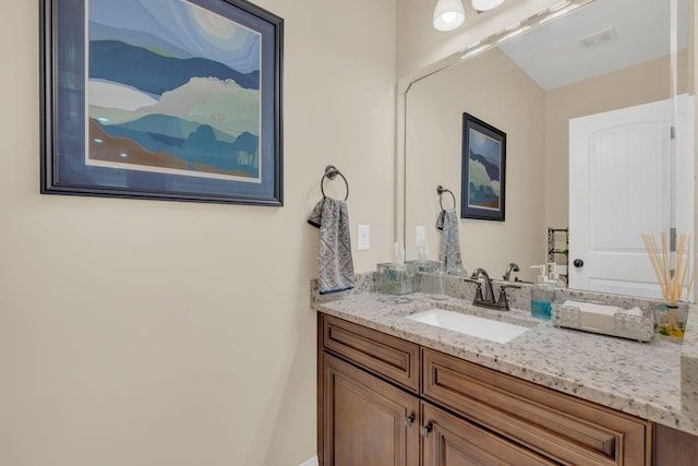bathroom featuring vanity and visible vents