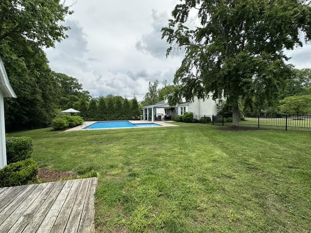 view of yard with fence and a fenced in pool