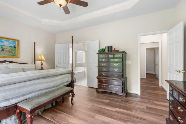 9404 Dove Field Ct, Brentwood, TN 37027 - bedroom featuring wood finished floors, ensuite bath, crown molding, a raised ceiling, and baseboards