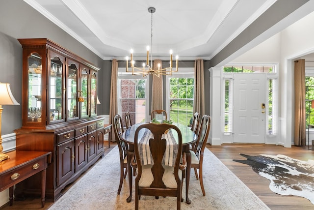 9404 Dove Field Ct, Brentwood, TN 37027 - dining room with a tray ceiling, light wood-style floors, ornamental molding, and a notable chandelier