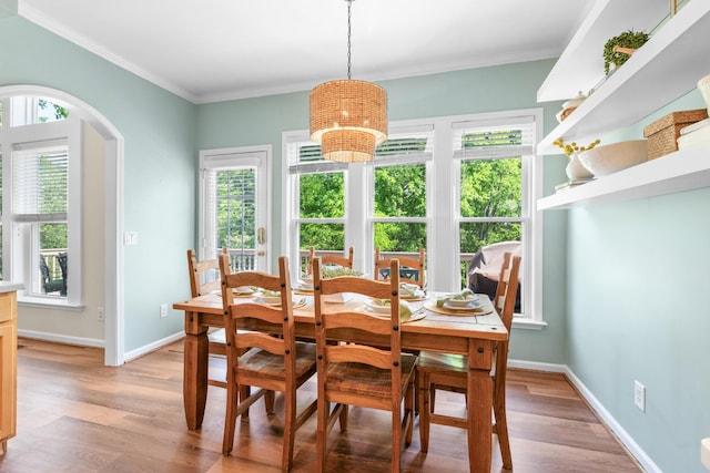 9404 Dove Field Ct, Brentwood, TN 37027 - dining area with ornamental molding, arched walkways, light wood-type flooring, and baseboards