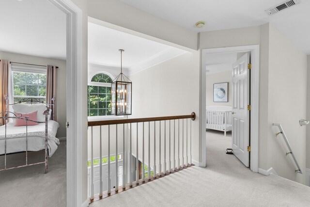 9404 Dove Field Ct, Brentwood, TN 37027 - hall featuring an upstairs landing, visible vents, a chandelier, carpet floors, and baseboards
