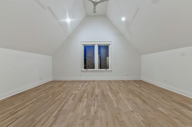 bonus room with a ceiling fan, baseboards, light wood-style flooring, and lofted ceiling