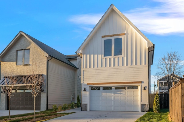 view of front facade with board and batten siding, brick siding, fence, an attached garage, and concrete driveway