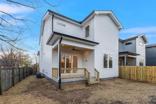 rear view of house featuring cooling unit, a ceiling fan, and a fenced backyard