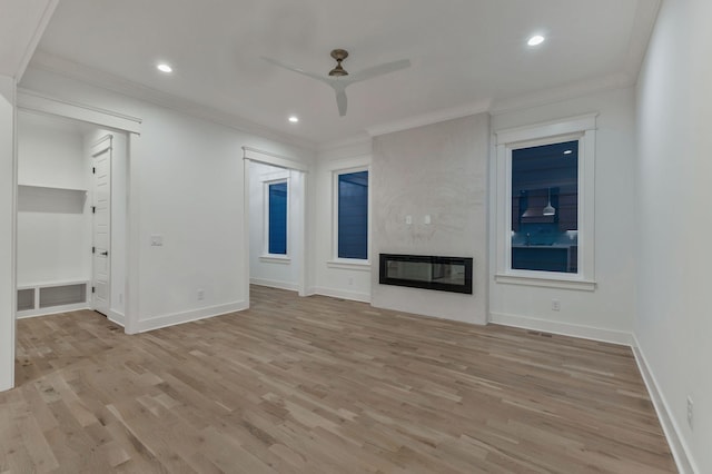 unfurnished living room featuring light wood-type flooring, ornamental molding, ceiling fan, and baseboards