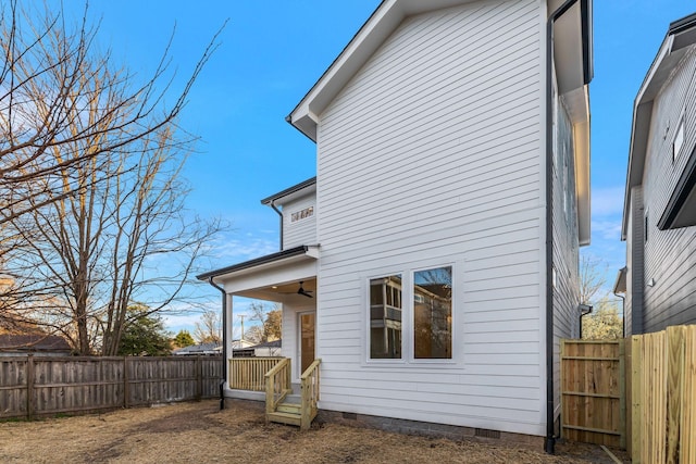back of house with crawl space and a fenced backyard