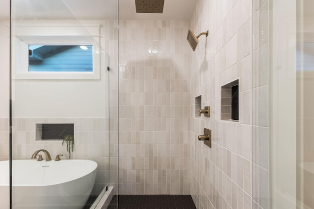 full bath featuring tile walls, tiled shower, and a soaking tub