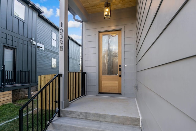 doorway to property featuring board and batten siding