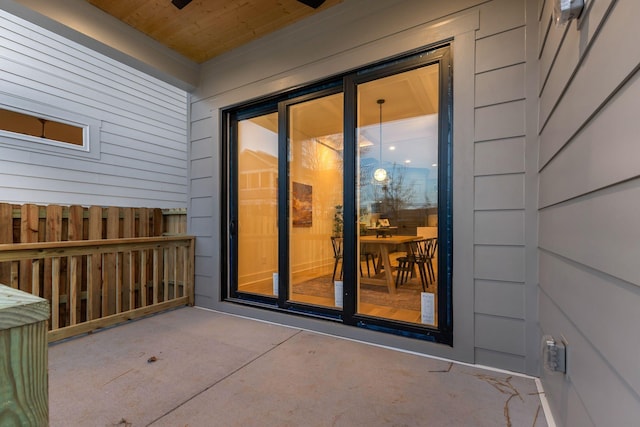 doorway to property featuring fence
