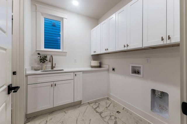 laundry room featuring a sink, cabinet space, marble finish floor, washer hookup, and baseboards