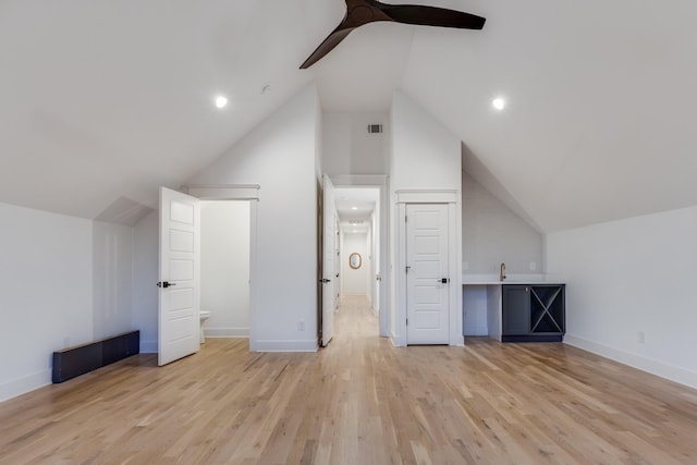 bonus room featuring a ceiling fan, visible vents, baseboards, light wood-style floors, and vaulted ceiling