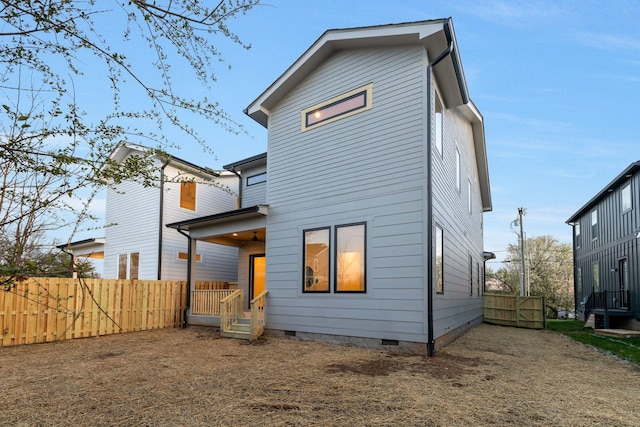 back of house with fence and crawl space
