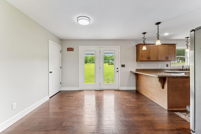 4 Earl Steel Rd W, Brush Creek, TN 38547 - kitchen featuring brown cabinets, dark wood-type flooring, decorative light fixtures, and a breakfast bar area