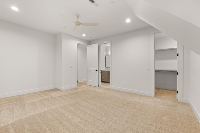 unfurnished bedroom featuring light colored carpet, visible vents, a spacious closet, and recessed lighting