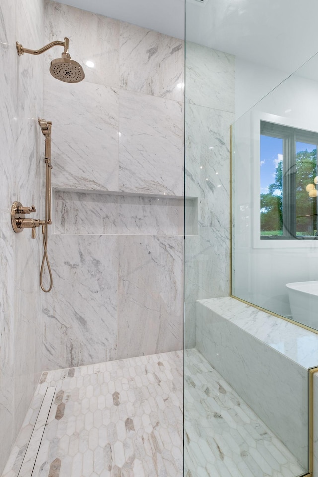 full bath with a marble finish shower