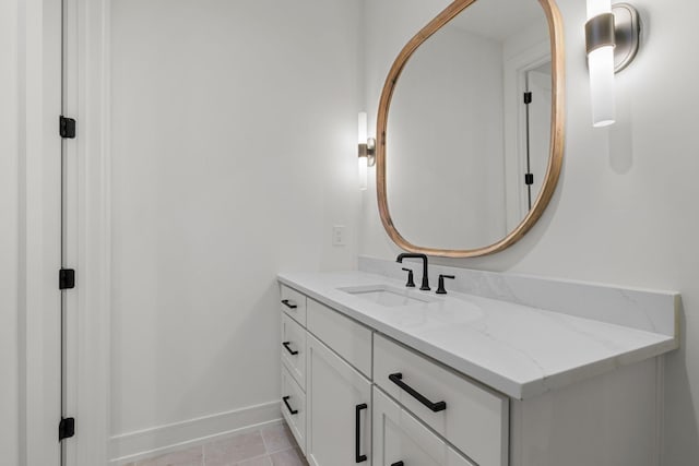 bathroom with tile patterned floors, baseboards, and vanity
