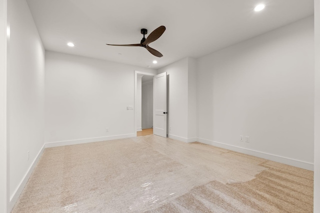 spare room with a ceiling fan, baseboards, recessed lighting, and light colored carpet