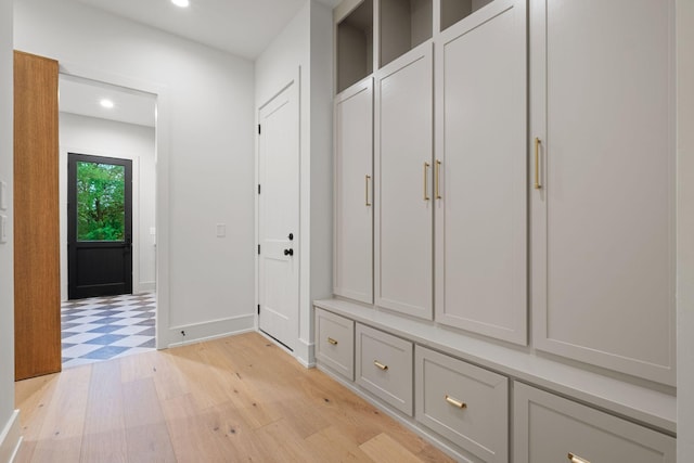 mudroom featuring baseboards, light wood-type flooring, and recessed lighting