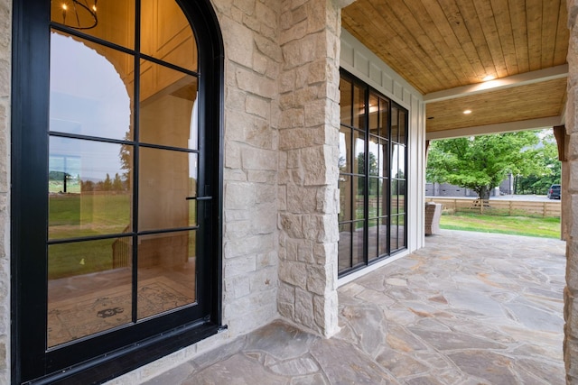 view of exterior entry featuring stone siding