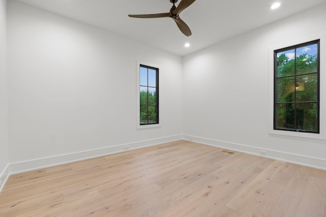 empty room featuring visible vents, recessed lighting, a ceiling fan, baseboards, and light wood-style floors