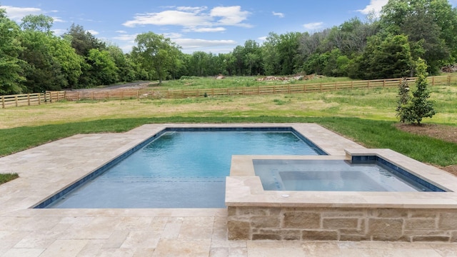 pool featuring a yard, an in ground hot tub, a fenced backyard, and a patio