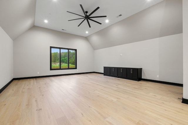 additional living space featuring lofted ceiling, a ceiling fan, and light wood-style flooring