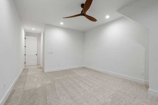 spare room featuring light colored carpet, baseboards, ceiling fan, and recessed lighting