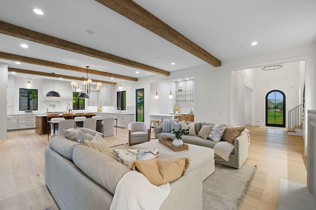 living area with light wood-style floors, plenty of natural light, and recessed lighting