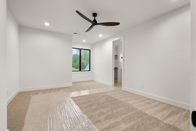 empty room with ceiling fan, light carpet, baseboards, and recessed lighting