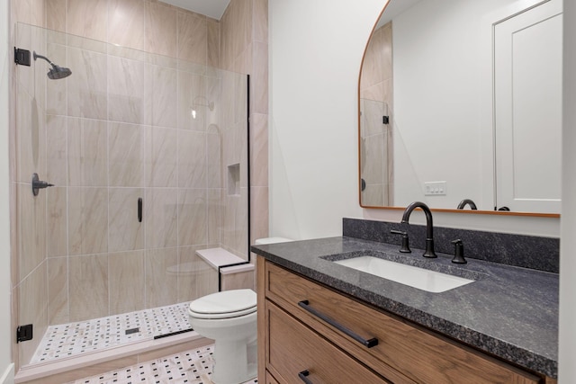full bathroom with vanity, toilet, and a shower stall