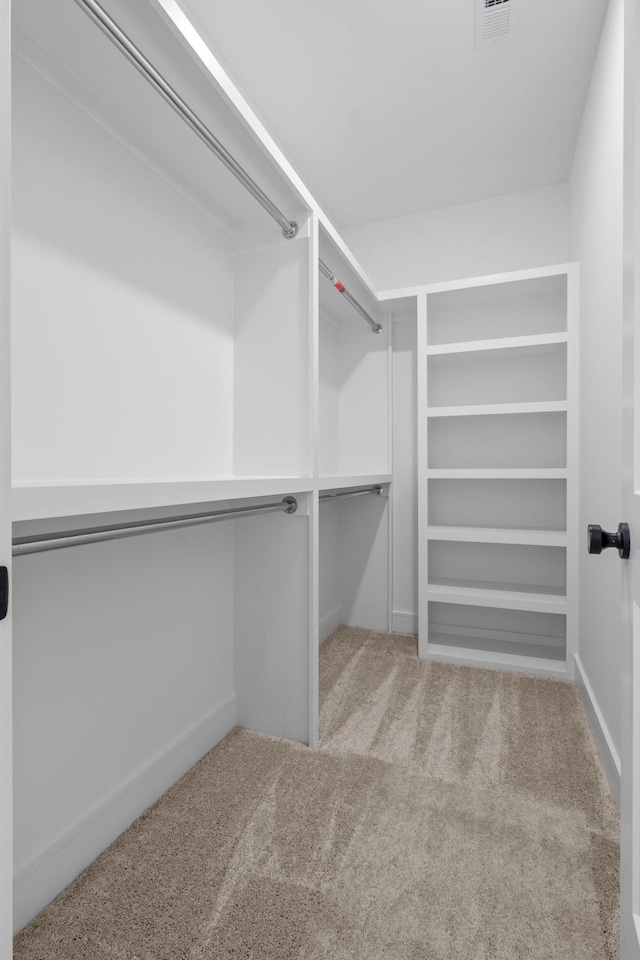 spacious closet with carpet flooring and visible vents