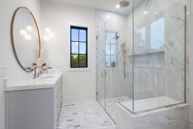 bathroom featuring a marble finish shower, baseboards, vanity, and visible vents