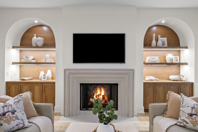 living room with light wood finished floors and a fireplace with flush hearth
