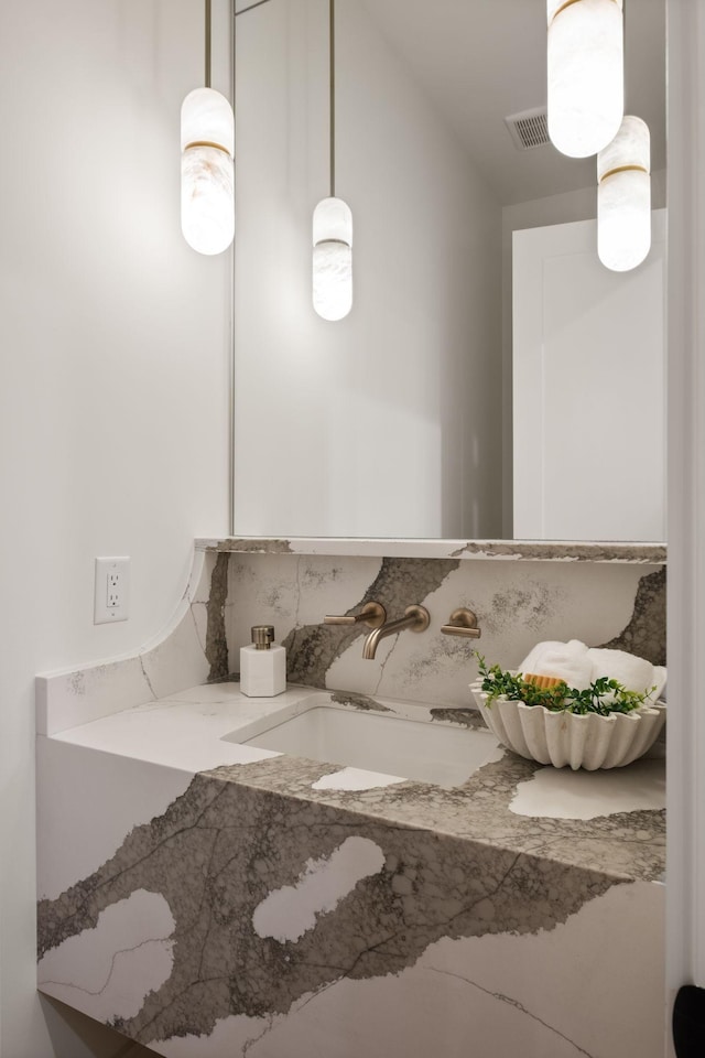 bathroom with a sink and visible vents