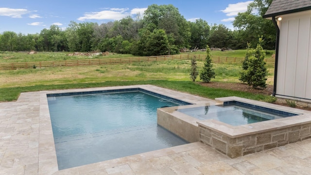 view of swimming pool featuring a fenced backyard, a fenced in pool, a rural view, a lawn, and an in ground hot tub