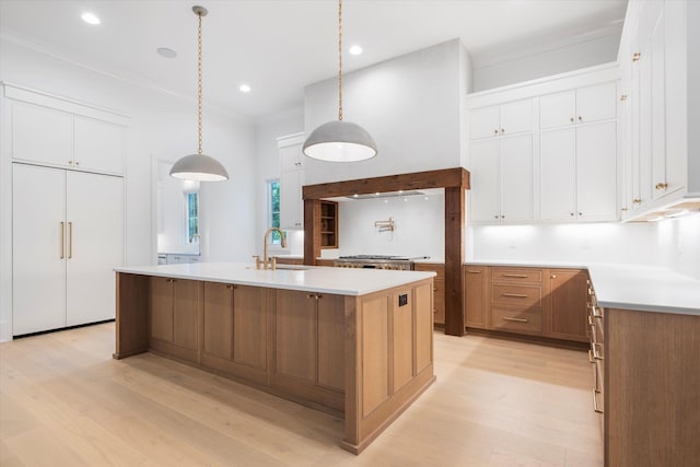 1408 Adams St, Franklin, TN 37064 - kitchen featuring a sink, light wood-type flooring, a kitchen island with sink, paneled fridge, and white cabinetry