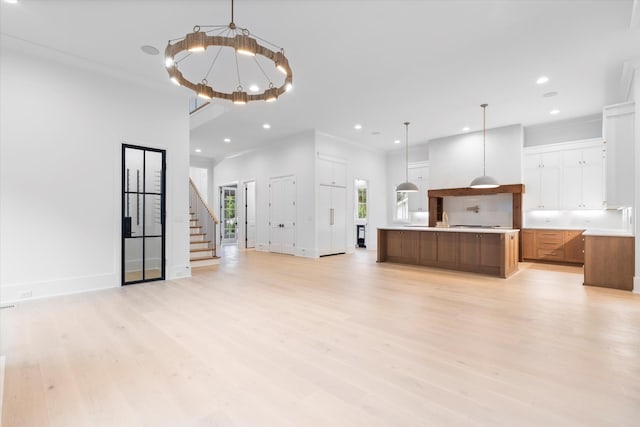 1408 Adams St, Franklin, TN 37064 - unfurnished living room with light wood finished floors, recessed lighting, stairway, baseboards, and ornamental molding