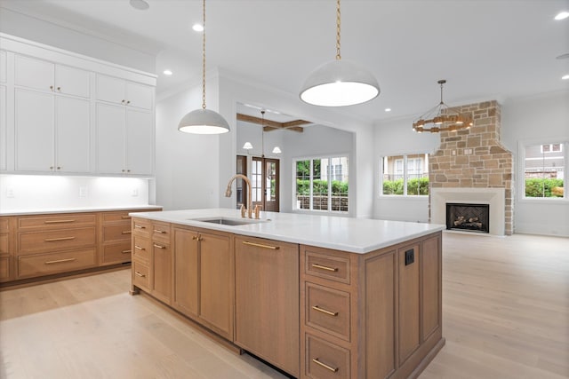 1408 Adams St, Franklin, TN 37064 - kitchen with a sink, light wood-type flooring, white cabinets, light countertops, and decorative light fixtures