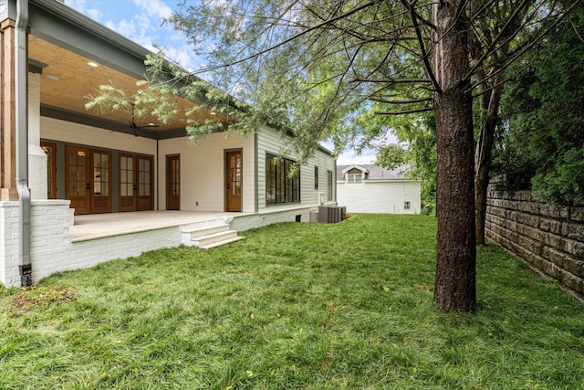 1408 Adams St, Franklin, TN 37064 - view of grassy yard with french doors, central AC, and a porch