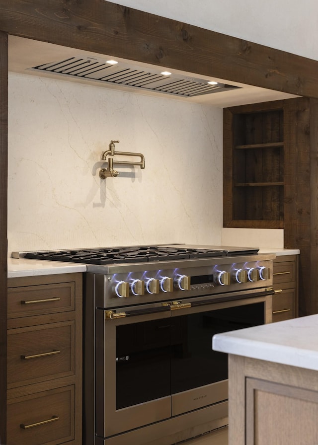 1408 Adams St, Franklin, TN 37064 - kitchen featuring stainless steel range with gas stovetop, open shelves, light stone countertops, and custom exhaust hood