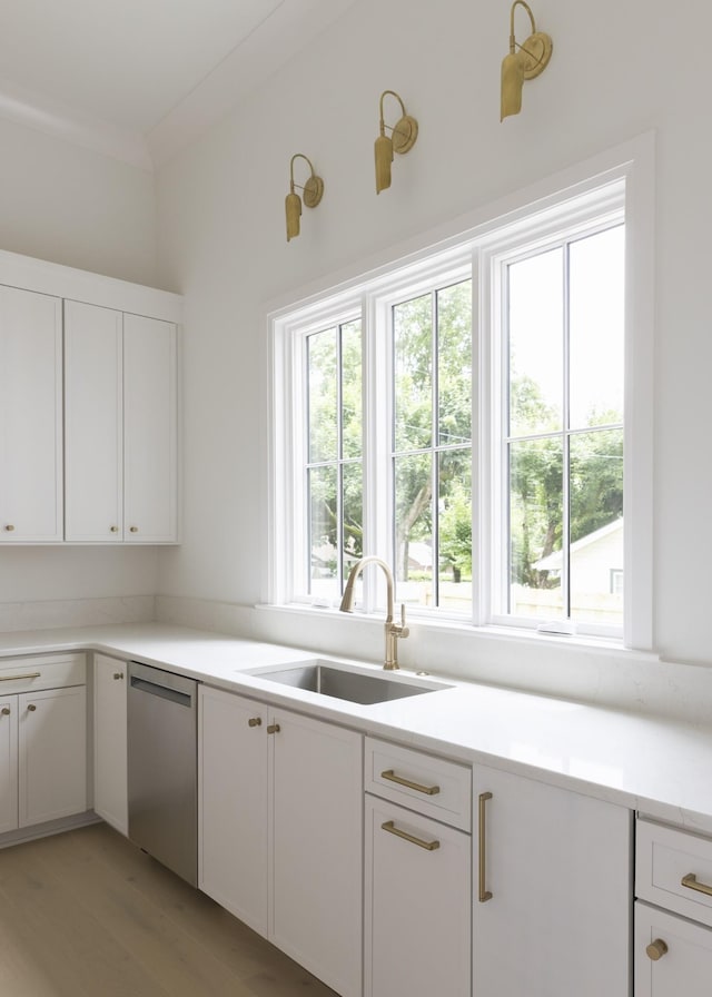 1408 Adams St, Franklin, TN 37064 - kitchen featuring stainless steel dishwasher, white cabinetry, light wood finished floors, and light countertops